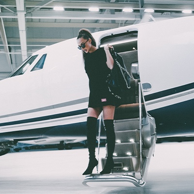 Woman exiting a private jet