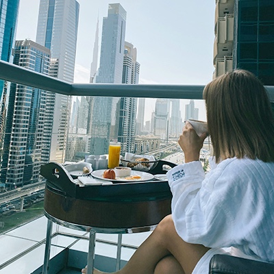Woman having breakfast in city