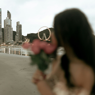 Woman overlooking city on a beach