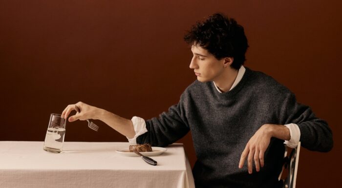 Man eating steak dinner alone