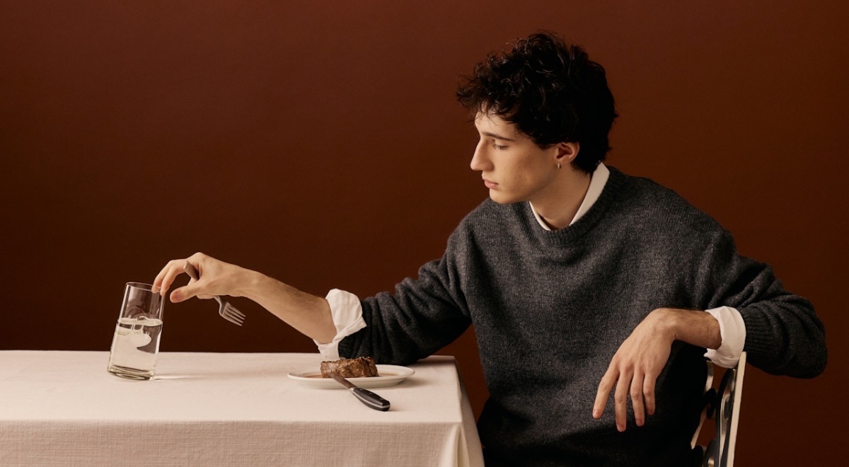Man eating steak dinner alone