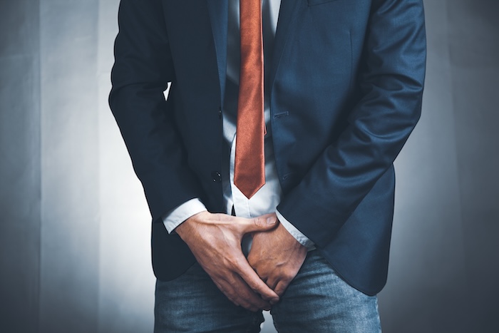 Man holding his crotch