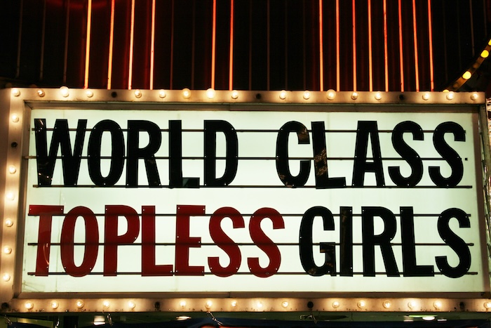 World Class Topless Girls on a marquee in a strip club