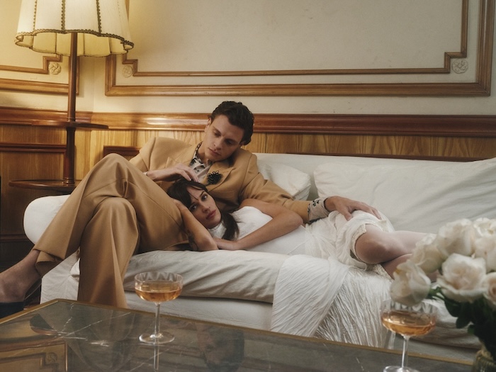 Stylish couple resting on couch