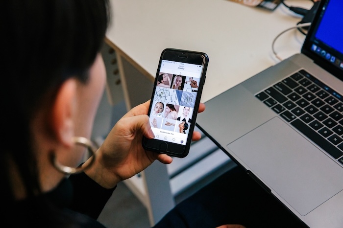 Woman viewing a mood board collage on her phone