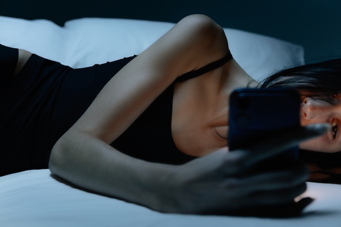 Woman with insomnia on her phone