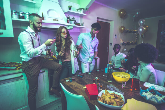 A group of young people celebrating and making party at home